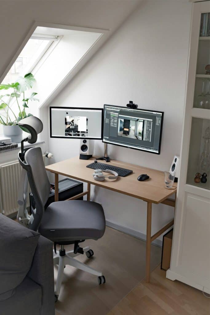 Compact dual monitor setup with monitor arms on a small desk