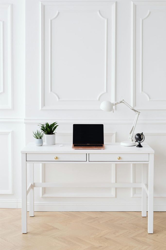 Minimal white desk setup for a small home office